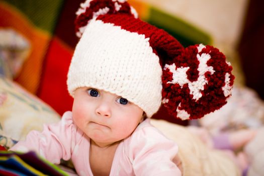 cute little baby in wool hat with big pompoms