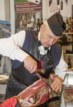 Man cutting a spanish ham - jamon serrano