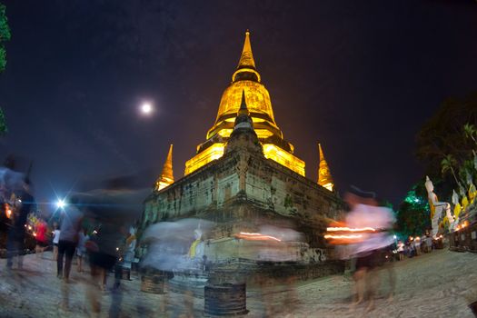 Religion Crowd walking with Candle Light around Temple in Makabucha day at Wat Yai Chaimongkol in Ayutthaya, Thailand