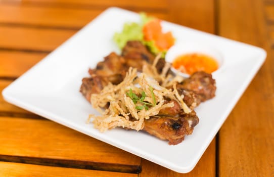 Fried Chicken and herb with Sauce thai food on wood table