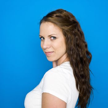 Portrait of a young girl on blue background