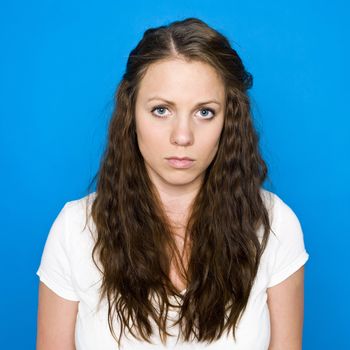 Portrait of a young girl on blue background