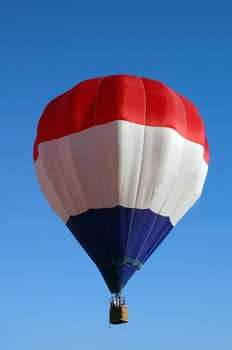 A balloon with white stripes, red and blue
