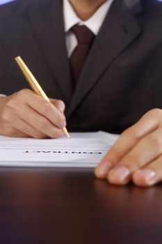 stock image of bussiness man signing contract