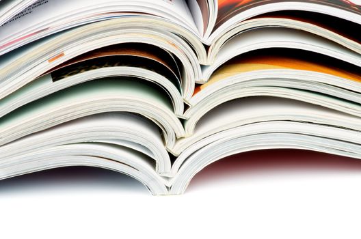 Stack of Various Open Magazines closeup on white background