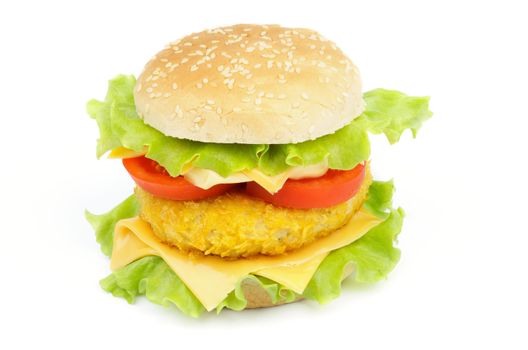 Sandwich with Breaded Chicken, Lettuce, Tomatoes and Cheese on Sesame Bun isolated on white background