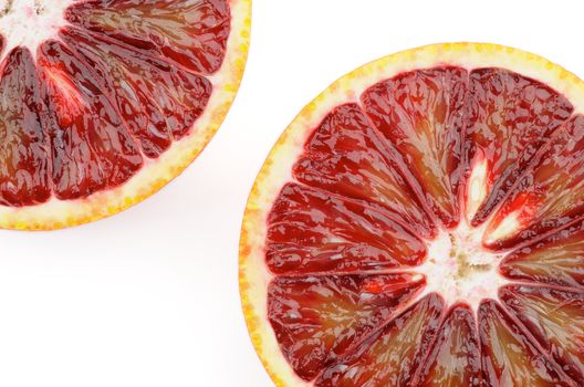 Two Blood Oranges in Half closeup on white background