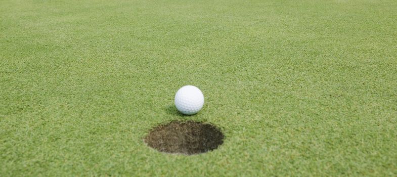 Close-up of a golf ball lying on the course