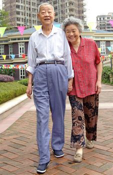 an intimate senior couple are walking