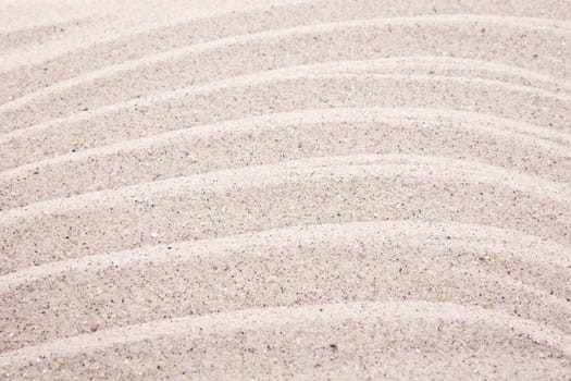 Abstract background of white sand ripples at the beach