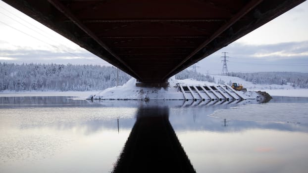 
Road bridge. View from below. Specular reflection on the water
