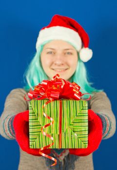 Teen girl holds a Christmas present