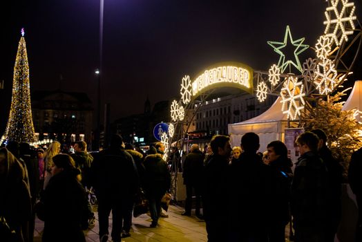 HAMBURG - DECEMBER 1, 2012: People visit traditional Christmas market around Alster river in Hamburg, Germany on December 1, 2012. The famous Hamburg Christmas market is located around the town hall and is a popular tourist attraction due to its gorgeous decorated stands.