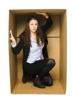 Woman in a cardboard box isolated on white background