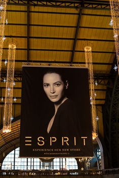 HAMBURG - DECEMBER 1, 2012: Beautiful Christmas decoration and poster advertising the opening of the latest Esprit fashion store in the main station of Hamburg, Germany on December 1, 2012. Esprit Holdings Limited is a worldwide fashion brand located on the Bermuda islands being present in more than 40 countries.