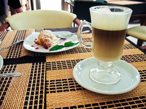 Breakfast with coffee and croissants on table