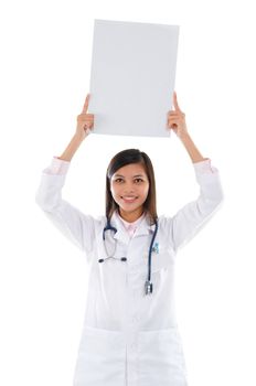 Southeast Asian female medical doctor showing white blank card on top of head, isolated on white background.