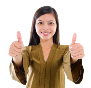 Southeast Asian Muslim female in traditional kebaya with long black hair giving thumbs up sign with great smile standing isolated on white background.