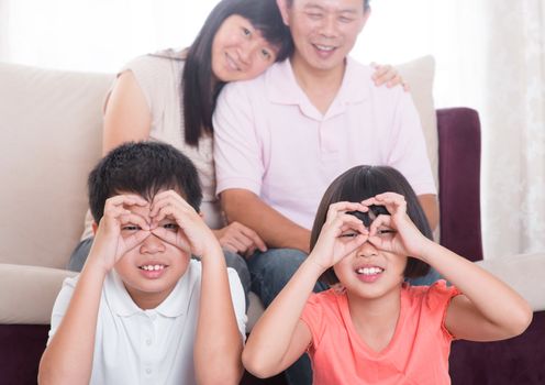 Southeast Asian family having fun at home