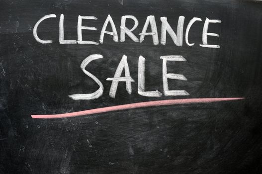 Clearance sale written with chalk on a blackboard