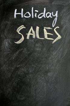 Holiday sales written with chalk on a blackboard
