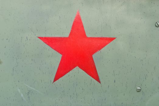 Red army symbol on green metal background texture.