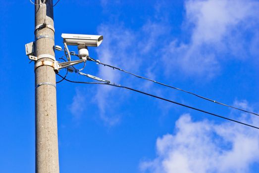 White CCTV on the concrete pole, taken on sunny winter morning