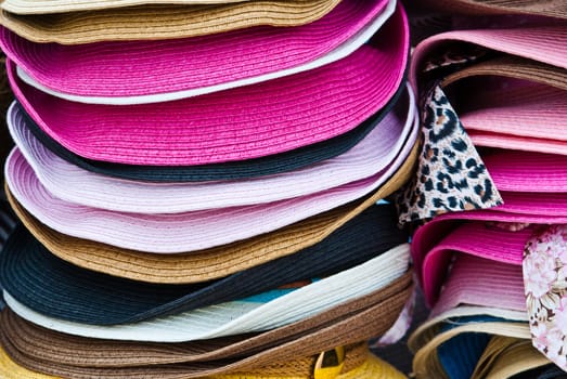 Stacks of colorful summer hats
