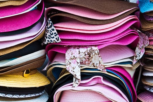 Stacks of colorful summer hats
