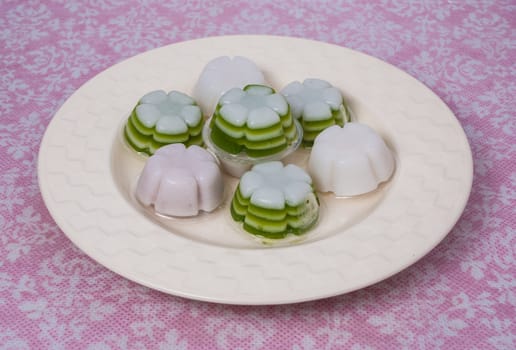 A simple but delicious dessert with a layer of white coconut milk and flour over a layer of colored gelatin. Typically the color is natural (green coloring comes from the Pandan leaf that also gives the gelatin a pleasant taste.