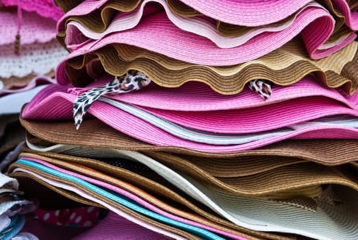 Stacks of colorful summer hats
