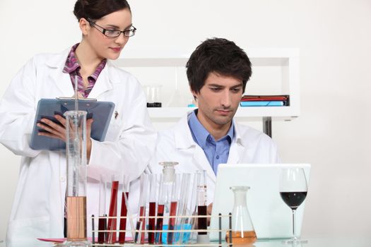 Couple working in a wine laboratory