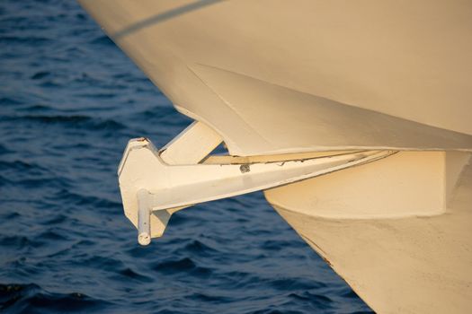 Ship anchor lifted up, with blue sea background