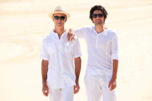 Father and son stood on beach