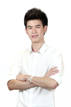 Portrait of a happy Asian teenage standing with arms crossed isolated against white background