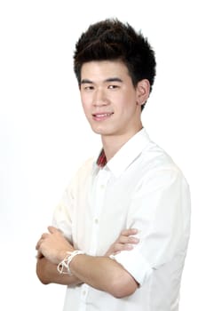 Portrait of a happy Asian teenage standing with arms crossed isolated against white background