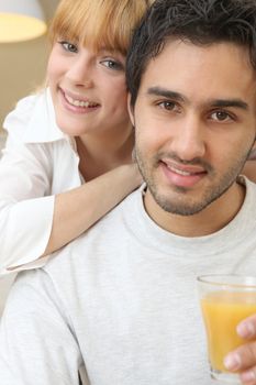 Couple with a glass of orange juice