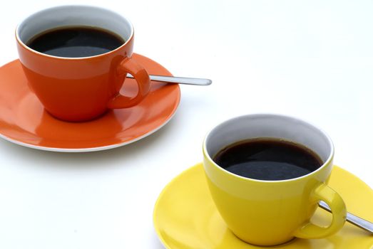 Two isolated cups of coffee.