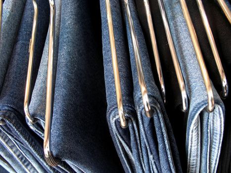 A rack full of hanging jeans.