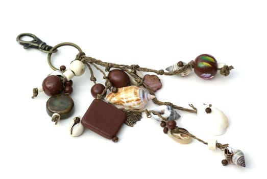 An isolated key ring with beads and shells.