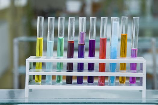 Colorful test tubes containing different solutions in a laboratory.