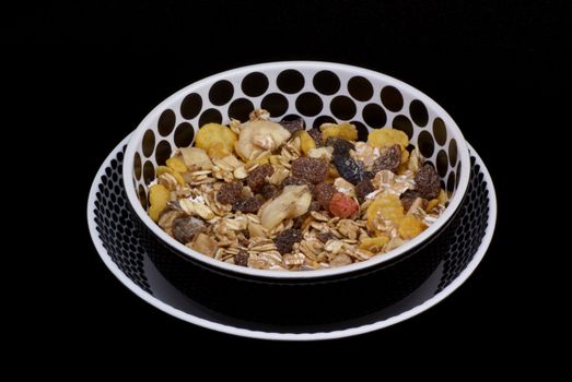 Bowls with muesli on a black background.