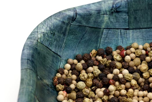 An isolated bowl of peppercorns.