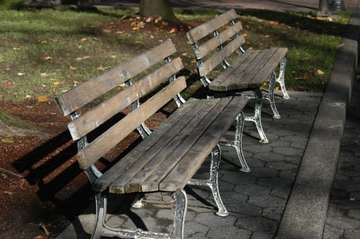 Two park benches in an urban park