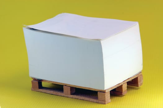 wooden paper palete miniature in yellow background