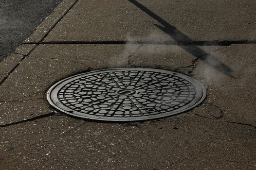                                 Closeup of a manhole in an urban city