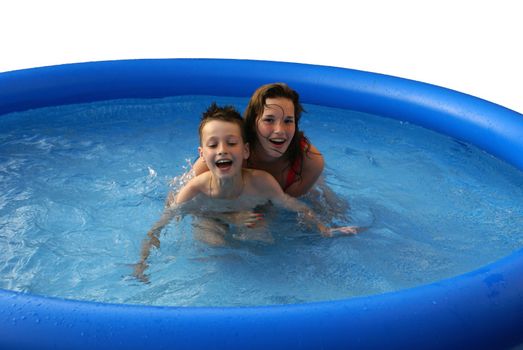 Two kids having fun in a swimming pool.