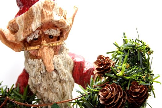 A wooden carving of Santa Claus elf on white background.