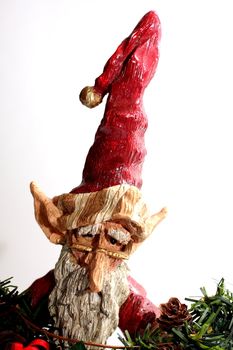A wooden carving of Santa Claus elf on white background.