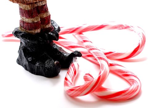 Wooden carving of elf slippers and candy canes